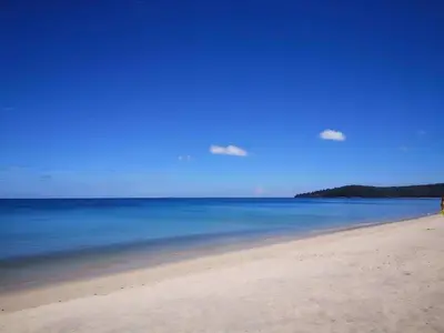 a view of a beach with the sky and water at Triple J Hometel in Bang Tao Beach
