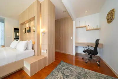a bedroom with a bed and a desk and a chair at Deluxe apartment at Icon Park by Lofty in Kamala Beach