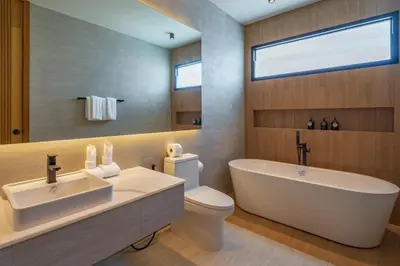 a bathroom with a tub and a toilet and a sink at Modern 4BR Villa with Private Pool in Bangtao in Bang Tao Beach
