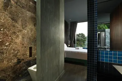 a bedroom with a bed and a bathroom with a tub at Seclusion in the mountains, villa near Kamala beach in Kamala Beach