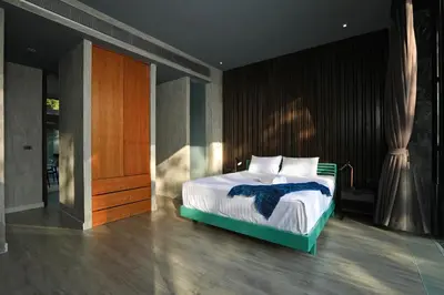 a bedroom with a bed with white sheets and pillows at Seclusion in the mountains, villa near Kamala beach in Kamala Beach