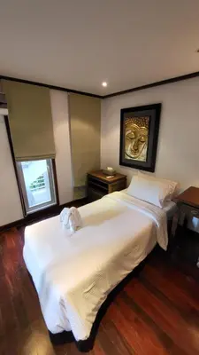a bedroom with a large white bed with a painting on the wall at Villa Mauao - Luxury Villa in Katamanda, Kata in Kata Beach