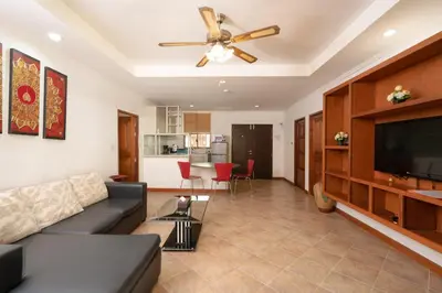 a living room with a couch and a flat screen tv at Sai Rougn apartment in Patong Beach