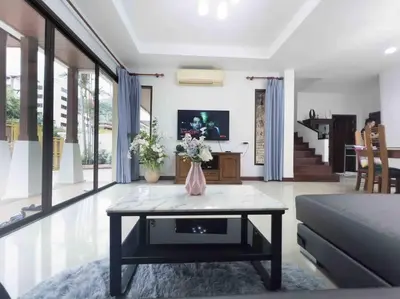 a living room with a table with flowers on it at 4BD Private pool villa in Patong heart quiet&nice in Patong Beach