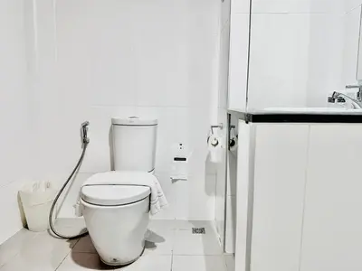 a white bathroom with a toilet and a shower at Ahad Suite Aonang in Ao Nang Beach