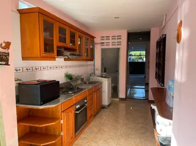 a kitchen with wooden cabinets and a microwave at Cozy Home With Lake View at Kathu PHUKET 3 BR in Ban Huai Luk (1)