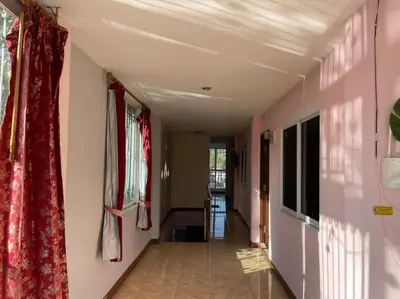 a hallway in a house with pink walls and curtains at Cozy Home With Lake View at Kathu PHUKET 3 BR in Ban Huai Luk (1)