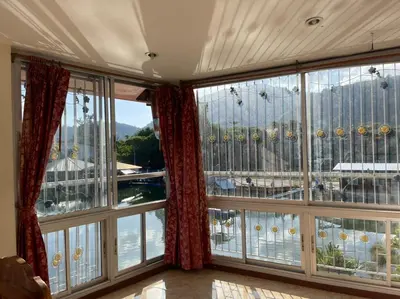 a room with large windows with a view of the water at Cozy Home With Lake View at Kathu PHUKET 3 BR in Ban Huai Luk (1)