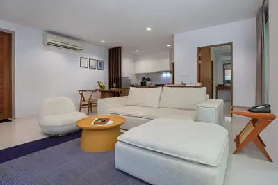 a living room with a couch and a chair at Surin Park by Destada in Surin Beach