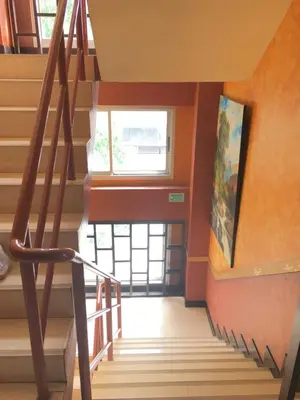 a staircase in a house with orange walls at 99 Residence in Patong Beach