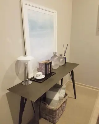 a table in a room with a lamp and a window at Baan Maikhao pool villa in Mai Khao Beach