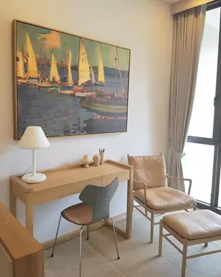 a room with a desk and chairs and a painting of sailboats at Baan Maikhao pool villa in Mai Khao Beach