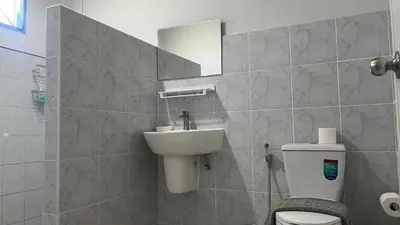 a bathroom with a sink and a toilet and a mirror at Karon House 15C in Karon Beach
