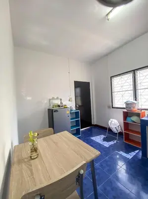 a kitchen with a wooden table and a refrigerator at Karon House 15C in Karon Beach