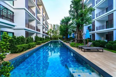 a swimming pool in the courtyard of a building at Direct pool access 2br apartment @The Title Rawai in Rawai Beach