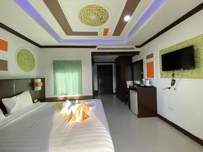 a bedroom with a bed with a tv on the ceiling at 77 Patong Hotel & Spa in Patong Beach