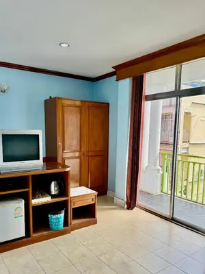 a living room with a tv and a window at Innarm House Patong in Patong Beach