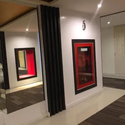 two pieces of art on display in a room at The Beach by Glitter House in Kata Beach