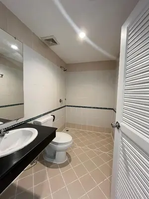 a bathroom with a toilet and a sink and a mirror at Cocoon Patong Hotel in Patong Beach