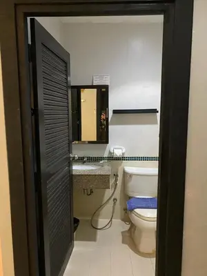 a bathroom with a toilet and a sink and a mirror at Lavender Patong Hotel in Patong Beach