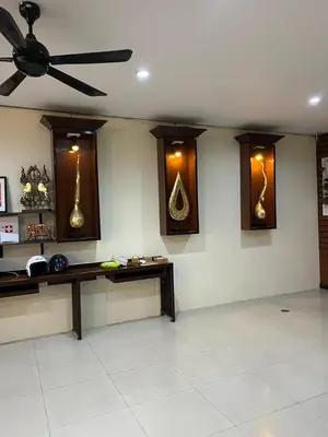 a living room with a ceiling fan and a table at Lavender Patong Hotel in Patong Beach