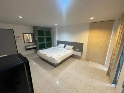 a bedroom with a bed and a flat screen tv at Cokoon Islanda Patong Hotel in Patong Beach