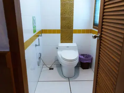 a bathroom with a white toilet in a room at Patong 4BD sea view BOOM party&cozy pool villa in Ban Nakhale