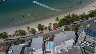 an aerial view of a beach with buildings and cars at Destination Patong in Patong Beach
