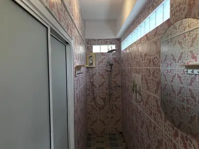 a bathroom with a shower with red tiles at Apartment kata in Kata Beach