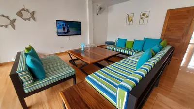 a living room with two couches and a table at 8 Palm Villa - Large Private Pool Villas in Aonang in Ao Nang Beach