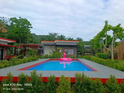 a swimming pool with a pink inflatable at Da-Kanda Boutique in Klong Muang Beach