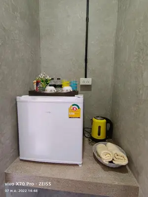 a white refrigerator in a kitchen with a bowl of cookies at Da-Kanda Boutique in Klong Muang Beach