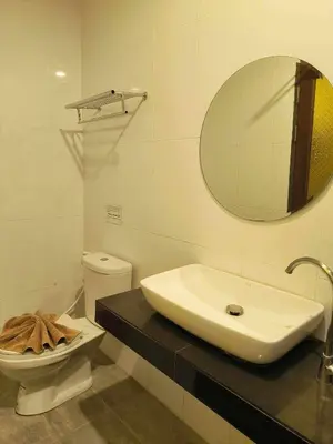 a bathroom with a sink and a toilet and a mirror at The Morning mini house aonang - 15-45 years old only in Ao Nang Beach