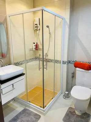 a bathroom with a shower with a toilet and a sink at Brand Naithon CondoC404 in Nai Thon Beach