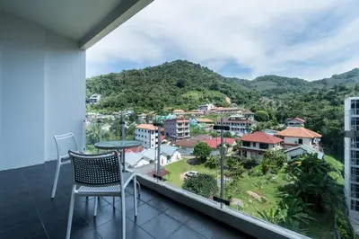 a balcony with a view of a city at Chic Condominium by Redfox Hospitality in Karon Beach