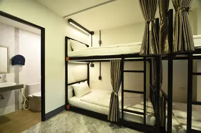 two bunk beds in a room with a mirror at KOKO Party Hostel 18-40 in Ao Nang Beach