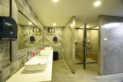 a bathroom with three sinks and two mirrors at KOKO Party Hostel 18-40 in Ao Nang Beach