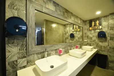 a bathroom with two sinks and a large mirror at KOKO Party Hostel 18-40 in Ao Nang Beach