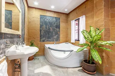 a bathroom with a tub and a sink and a plant at Villa Cologne​ @Nanai Villa in Patong Beach