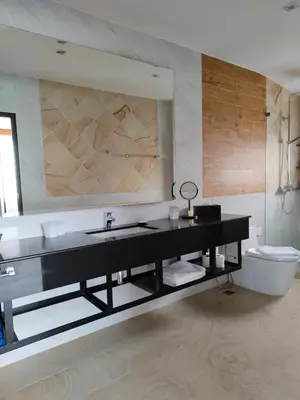 a bathroom with a black sink and a toilet at Phuket Jungle Experience Resort in Karon Beach