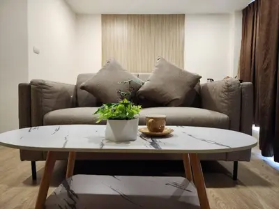 a living room with a couch and a coffee table at iCheck inn Darisa Patong in Patong Beach