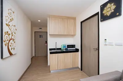 a hallway with a kitchen and a door to a room at iCheck inn Darisa Patong in Patong Beach