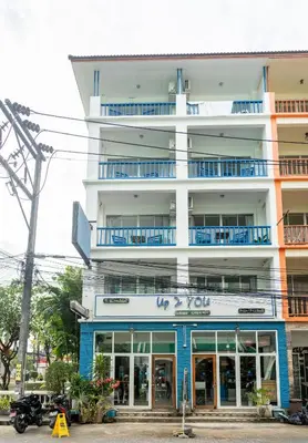 a white building with blue balconies on it at Meow Cat Cafe & Hotel in Patong Beach