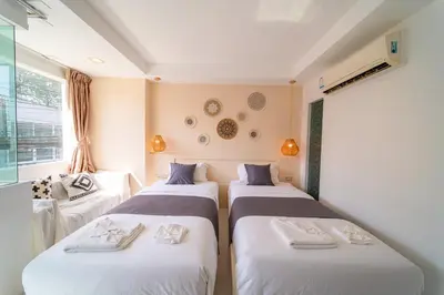 a room with two beds and a window at Catnip Seaside Hotel&Cafe in Ban Huai Luk (1)