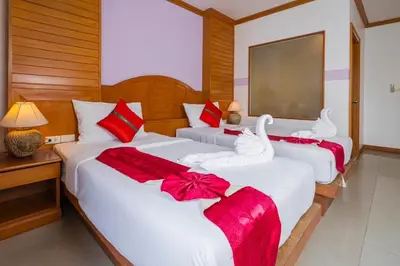 two beds in a hotel room with red and white bows at Sunshine Patong in Patong Beach