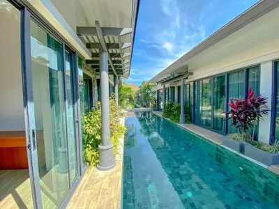 a swimming pool in the middle of a building at Tajh Pool Villas in Chalong