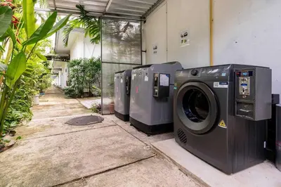 a row of washing machines sitting next to a building at Tajh Pool Villas in Chalong