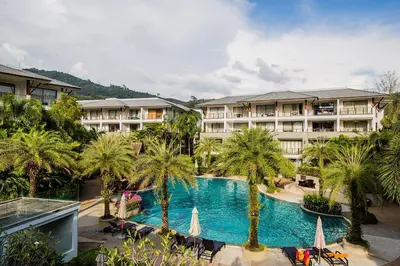 an aerial view of a hotel with a swimming pool and palm trees at Beachfront 2br home with private plunge pool on stunning Naithon beach 3 in Nai Thon Beach
