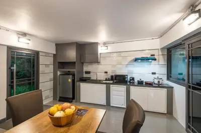 a kitchen with a table with a bowl of fruit on it at Loy Chalet in Klong Muang Beach