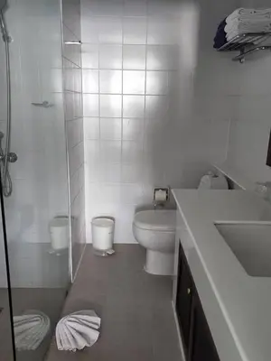 a white bathroom with a toilet and a sink at Andaman sea view private in Patong Beach